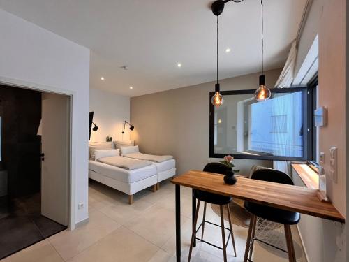 a kitchen and living room with a table and a couch at Goldstadt Apartments in Pforzheim