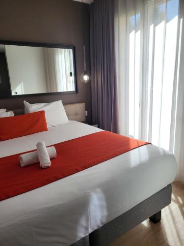 a bedroom with a large bed with two towels on it at Adagio Serris Val d'Europe in Serris