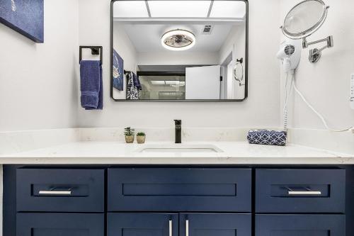 a bathroom with a sink and a mirror at Unwind with Beach Bliss & Sunset Magic - Sunburst 113 in Punta Gorda Beach