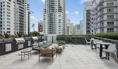 a balcony with chairs and tables and some buildings at Cadenza Miami - Luxury Residences in Miami
