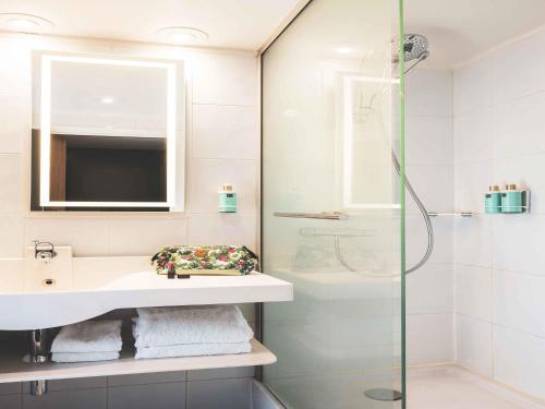 a bathroom with a sink and a shower at Novotel Paris Vaugirard Montparnasse in Paris