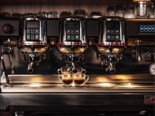a coffee machine with two cups on a counter at Novotel Paris Vaugirard Montparnasse in Paris
