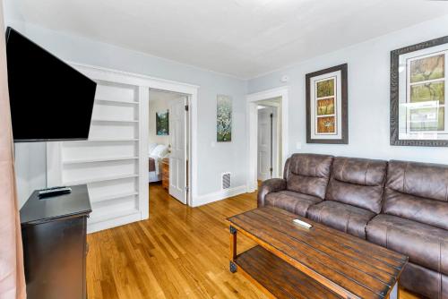 a living room with a couch and a tv at 2nd Base Apt 2 All Star Baseball Rentals in Oneonta