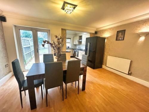 a kitchen and dining room with a table and chairs at 3 Bed Semi - Sleeps 5 - Wifi - Private Garden & Parking - Pets Allowed in Grove Park