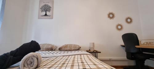 a bedroom with a bed with a tree on the wall at T4 rénové 95 m2 cosy confort ! in Anzin