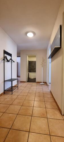 an empty room with a tile floor and a table at T4 rénové 95 m2 cosy confort ! in Anzin