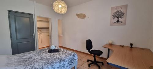 a bedroom with a bed and a desk and a chair at T4 rénové 95 m2 cosy confort ! in Anzin