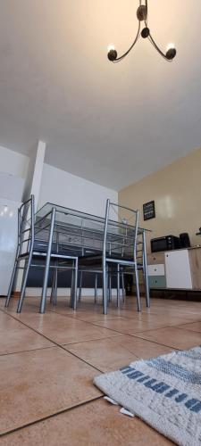 a dining room with a glass table and chairs at T4 rénové 95 m2 cosy confort ! in Anzin