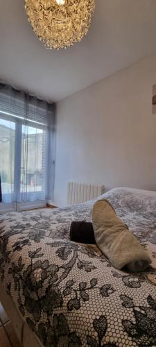 a bed with a pillow on it in a bedroom at T4 rénové 95 m2 cosy confort ! in Anzin