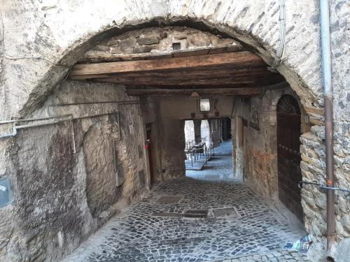 an alleyway in an old stone building with an arch at Al Campanile a stylish new apartment San Vito Romano Rome in San Vito Romano