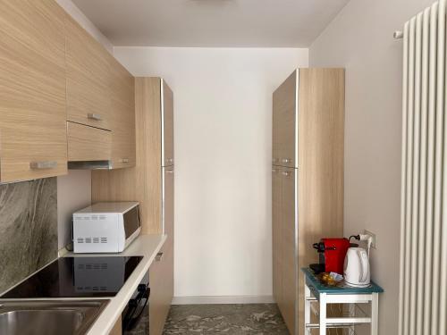 a kitchen with a sink and a microwave at Chiavenna Suite in Chiavenna
