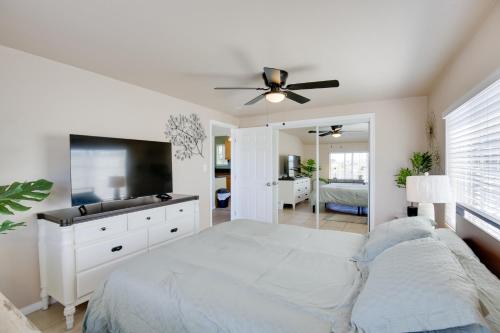 a white bedroom with a bed and a flat screen tv at 4 Mi to Dtwn San Diego Cozy Getaway with Patio! in San Diego