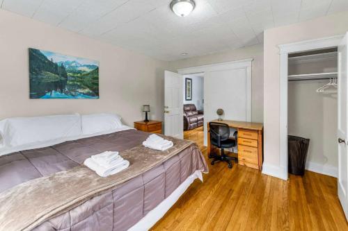 a bedroom with a bed and a desk and a television at 2nd Base Apt 2 All Star Baseball Rentals in Oneonta