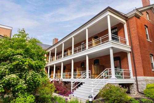 a large brick building with a white balcony at Inn at Diamond Cove in Portland
