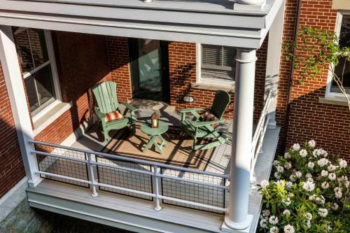 an aerial view of a balcony with a table and chairs at Inn at Diamond Cove in Portland
