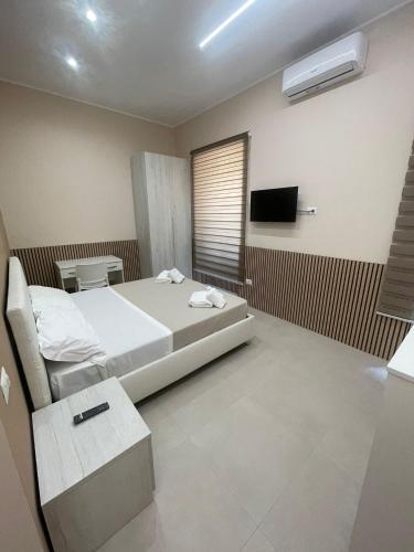 a bedroom with a bed and a tv in it at Catapano's House in Pompei