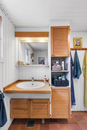 a bathroom with a sink and a mirror at BL1074-Saltum-Solmarken-3 in Saltum