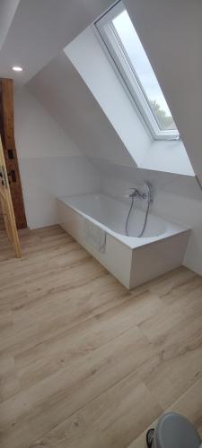 a white bath tub in a room with a window at Wustermark Ferienwohnung Dorfanger 8 in Wustermark