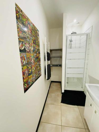 a bathroom with a sink and a painting on the wall at L'escale Urbaine avec fibre internet 4 pers Confort & Emplacement Idéal in Marmande