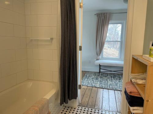 a bathroom with a bath tub and a window at Private duplex on Hudson River in Coxsackie