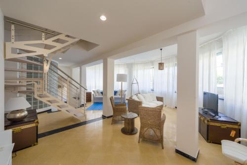 a living room with a spiral staircase and a living room at Cinque Terre Moneglia Apartments in Moneglia