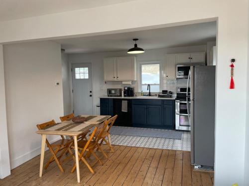 a kitchen with a table and chairs and a refrigerator at Private duplex on Hudson River in Coxsackie