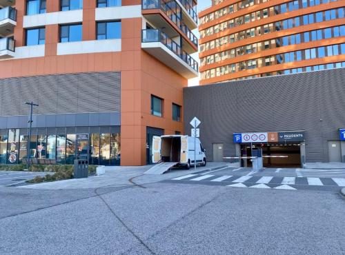 a food truck parked in front of a building at Stylish 19th-Floor Klingerka Apartment with Stunning Castle Views & Free Parking in Bratislava
