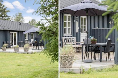 a house with a table and an umbrella at JB283-Frostrup-Andreas-Lassens-Vej-6 in Nørklit