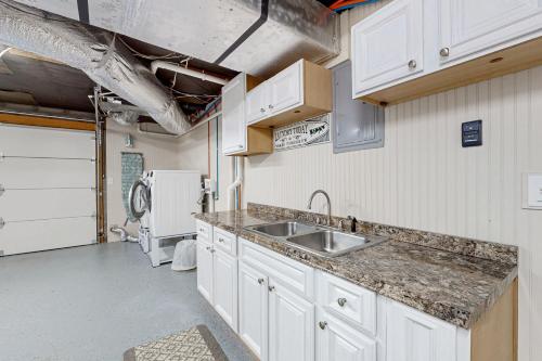 a kitchen with a sink and a refrigerator at Lake Life in Blairsville