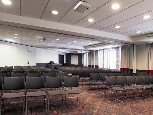 a conference room with chairs and a podium in it at Mercure Paris la Défense Grande Arche in Nanterre
