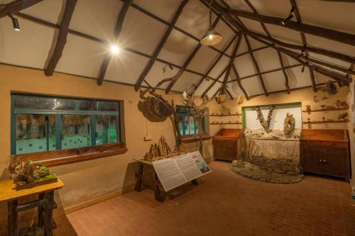 a large room with a fish tank in a building at Mud House by Paatlidun in Jāmb