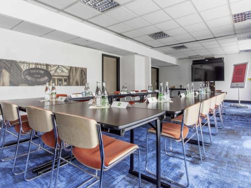 a conference room with a long table and chairs at ibis Styles Evry Courcouronnes Hotel and Events in Evry-Courcouronnes