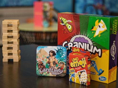 two boxes of games on a table next to wooden toys at ibis Styles Evry Courcouronnes Hotel and Events in Evry-Courcouronnes