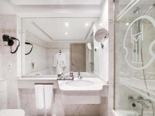 a white bathroom with a sink and a shower at Mercure Monte Igueldo in Donostia-San Sebastián