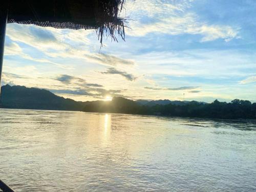 a view of a river with the sun reflecting on the water at Luangprabang That Luang Boutique House in Luang Prabang