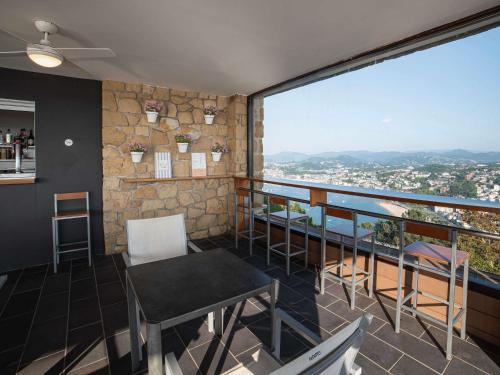 a room with a table and chairs and a large window at Mercure Monte Igueldo in Donostia-San Sebastián