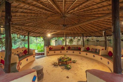 a large living room with couches and a large ceiling at Mud House by Paatlidun in Jāmb