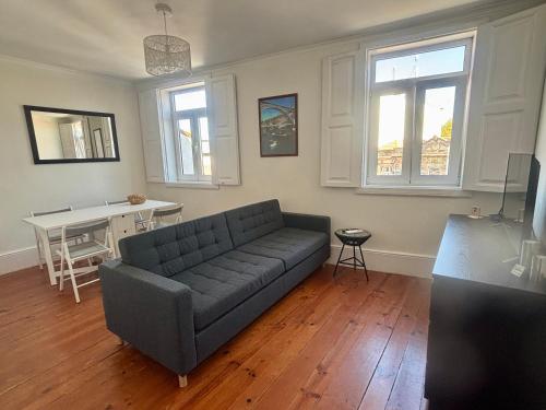a living room with a couch and a table at Pombeiro Apartments in Porto