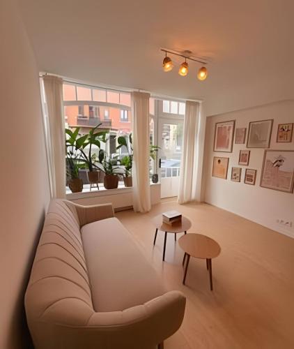 a living room with a couch and a table at Spacious suite with private bathroom in Brussels