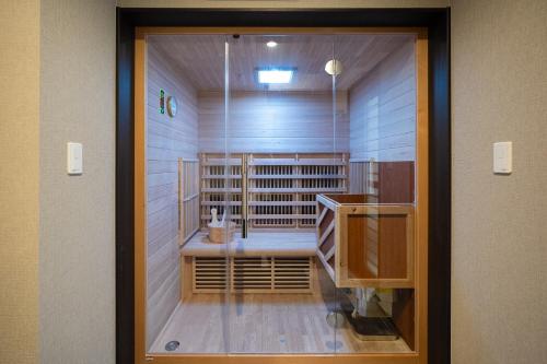 a door into a room with a wine cellar at UNZIPPER KUMAMOTO - Private Sauna Stay - in Kumamoto