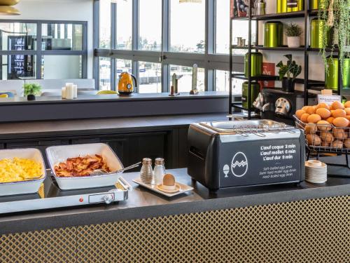 a buffet line with food on a counter at ibis Paris Porte de Montreuil in Paris