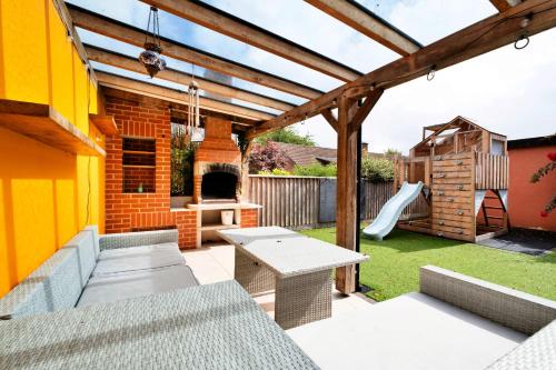 a patio with a table and a playground at Finest Retreats - Elizabeth House in Kington