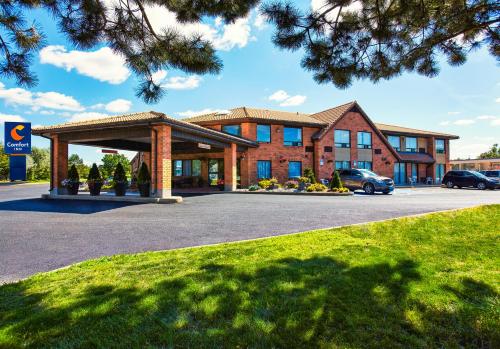 a hotel with a parking lot in front of it at Comfort Inn in Laval