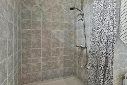a shower with a shower curtain in a bathroom at 30171-Odder-Pouli-Nielsensvej-71 in Beder