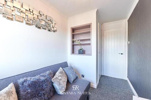 a living room with a couch and a chandelier at Long Stays - Cosy 3BR - Newcastle Retreat - RVI & City Centre - Garden - Parking - Near High Street in Kenton