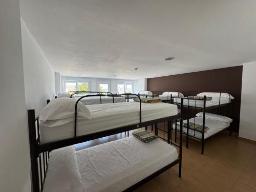 a group of bunk beds in a room at Albergue Internacional in Sarria