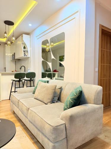 a living room with a couch and a kitchen at Lush Cove Apartments in Lekki