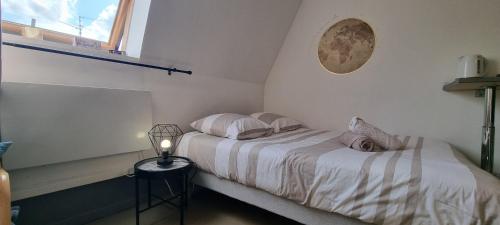 - une chambre avec un lit avec deux oreillers et une fenêtre dans l'établissement T1 rénové 26m2 cosy confort !, à Anzin