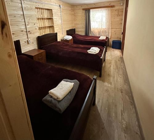 a small room with two beds and a couch at Pirikiti in Akhmety
