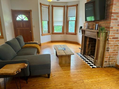 a living room with a couch and a fireplace at Jungle House Luxury Stays - Columbus Downtown Short North in Columbus